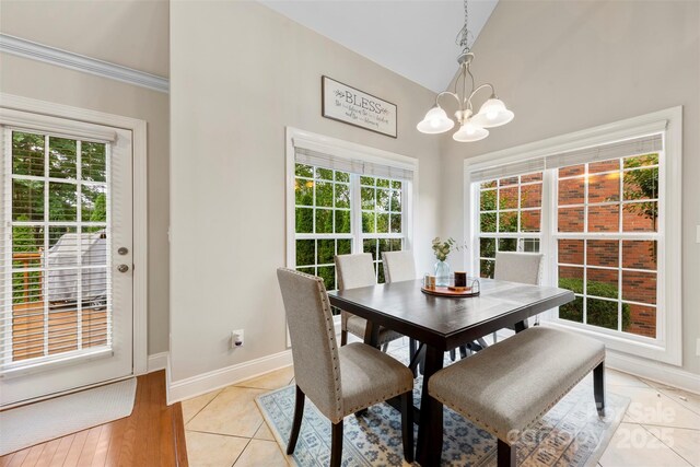 2563 Firethorn Ct, Gastonia, NC 28056 - dining area featuring a chandelier, baseboards, high vaulted ceiling, and light tile patterned floors