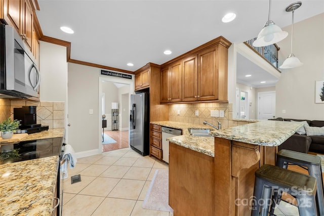 2563 Firethorn Ct, Gastonia, NC 28056 - kitchen with stainless steel appliances, a peninsula, light stone counters, a sink, and baseboards