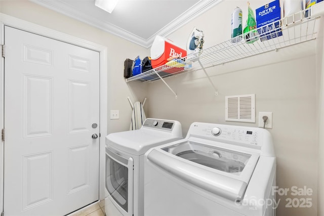 2563 Firethorn Ct, Gastonia, NC 28056 - laundry area featuring washing machine and dryer, crown molding, and tile patterned floors