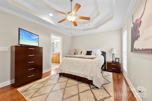 2563 Firethorn Ct, Gastonia, NC 28056 - bedroom featuring light wood finished floors, multiple windows, ornamental molding, a raised ceiling, and baseboards
