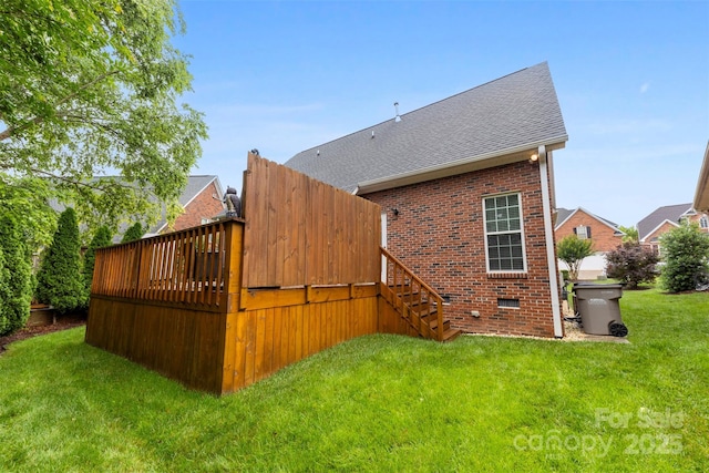 2563 Firethorn Ct, Gastonia, NC 28056 - back of property featuring brick siding, a yard, stairs, a shingled roof, and a wooden deck