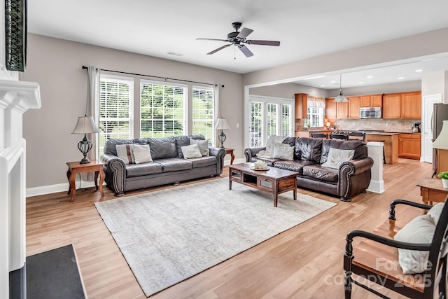 10792 Elsfield Ave NW, Concord, NC 28027 - living area featuring a ceiling fan, light wood-style floors, baseboards, and recessed lighting
