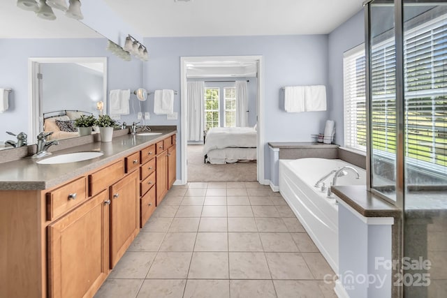 10792 Elsfield Ave NW, Concord, NC 28027 - ensuite bathroom featuring double vanity, a garden tub, tile patterned floors, and baseboards