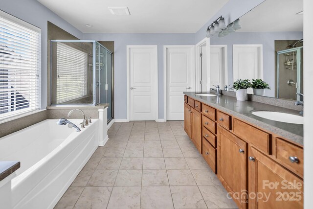 10792 Elsfield Ave NW, Concord, NC 28027 - full bathroom featuring double vanity, a stall shower, and a garden tub
