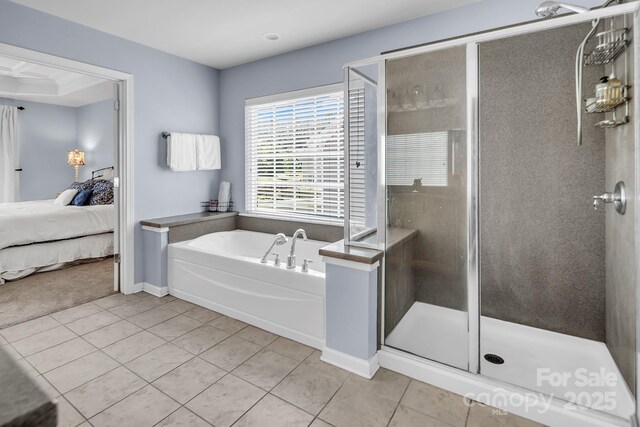 10792 Elsfield Ave NW, Concord, NC 28027 - bathroom with tile patterned flooring, a garden tub, a shower stall, ensuite bathroom, and baseboards