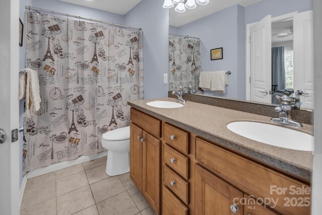 10792 Elsfield Ave NW, Concord, NC 28027 - full bath featuring toilet, double vanity, a shower with curtain, and tile patterned floors