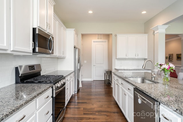 10016 St Kitts Landing Ln, Charlotte, NC 28278 - kitchen with appliances with stainless steel finishes, a sink, white cabinets, dark wood-type flooring, and recessed lighting