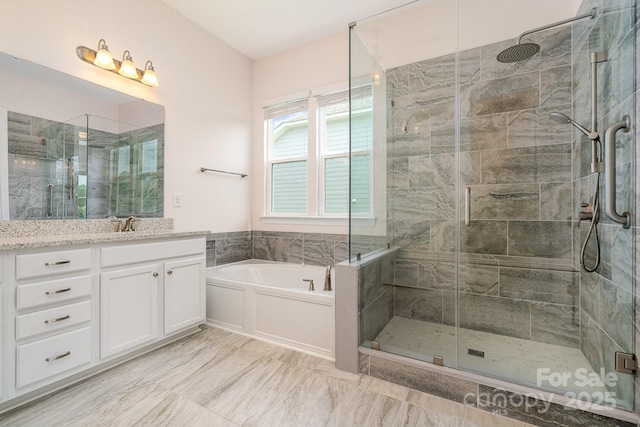 10016 St Kitts Landing Ln, Charlotte, NC 28278 - bathroom with vanity, a shower stall, a garden tub, and marble finish flooring