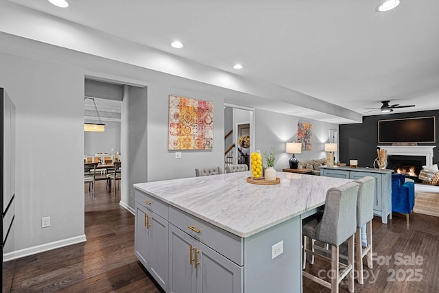 7331 Millstone Cir SW, Concord, NC 28025 - kitchen featuring open floor plan, a kitchen island, gray cabinetry, a ceiling fan, and recessed lighting