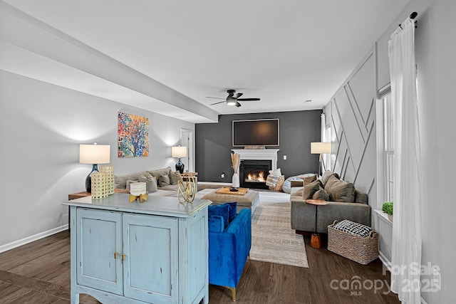 7331 Millstone Cir SW, Concord, NC 28025 - living area featuring ceiling fan, baseboards, a glass covered fireplace, and dark wood-style floors