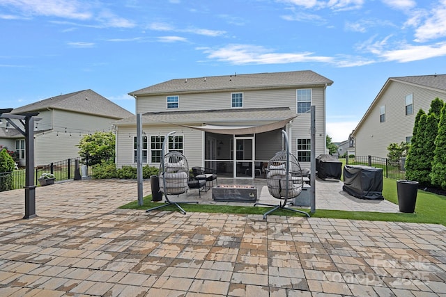 7331 Millstone Cir SW, Concord, NC 28025 - back of house featuring a patio area, an outdoor fire pit, and a sunroom