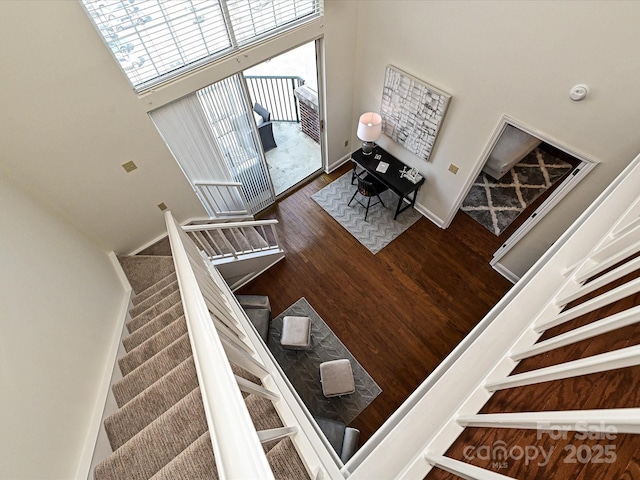 300 W 5th St Unit 723, Charlotte, NC 28202 - stairs featuring a high ceiling, wood finished floors, and baseboards