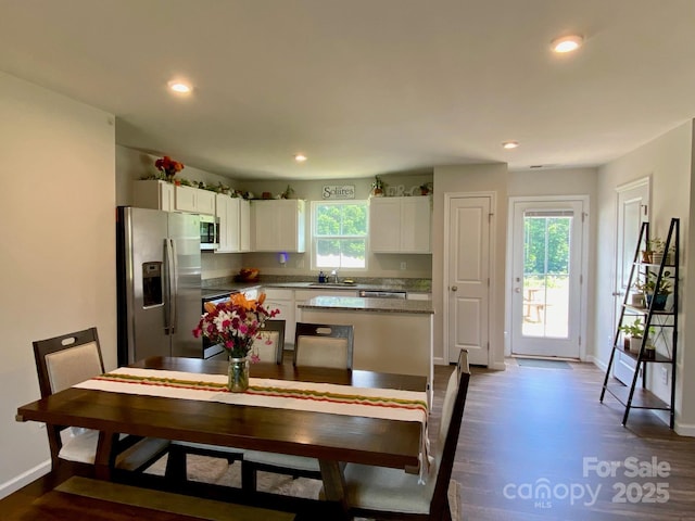 3113 Bouquet St, Charlotte, NC 28215 - kitchen with appliances with stainless steel finishes, white cabinets, dark wood-style floors, baseboards, and recessed lighting