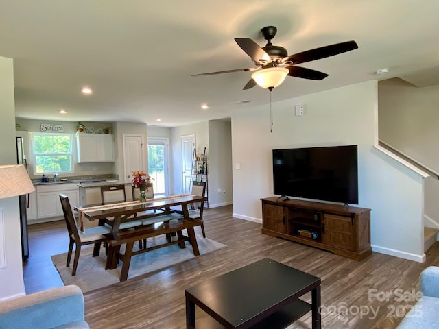 3113 Bouquet St, Charlotte, NC 28215 - living room featuring wood finished floors, baseboards, a ceiling fan, stairs, and recessed lighting
