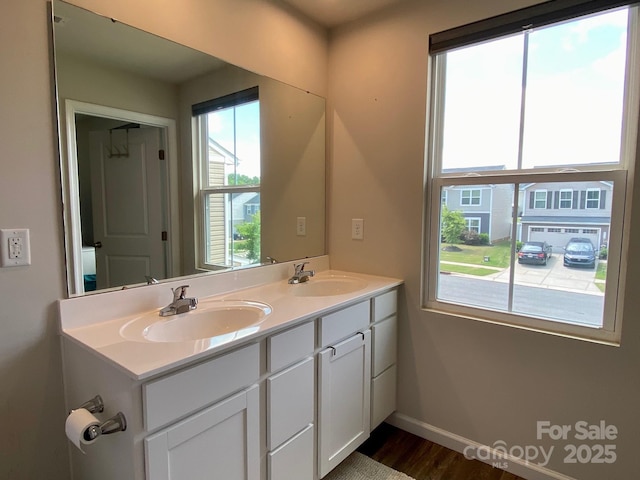 3113 Bouquet St, Charlotte, NC 28215 - full bathroom with double vanity, wood finished floors, and baseboards