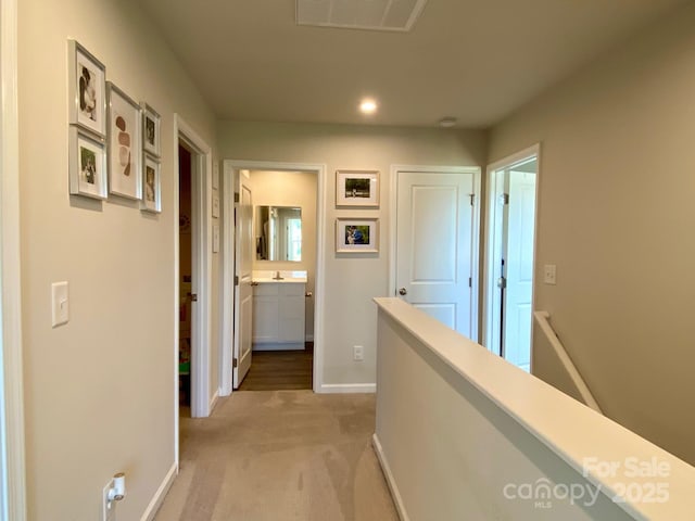 3113 Bouquet St, Charlotte, NC 28215 - hall with baseboards, light colored carpet, recessed lighting, and an upstairs landing