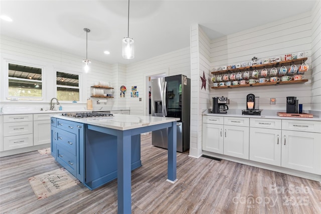 509 N Oak St, Lincolnton, NC 28092 - kitchen featuring open shelves, stainless steel appliances, light wood-style flooring, a sink, and white cabinetry