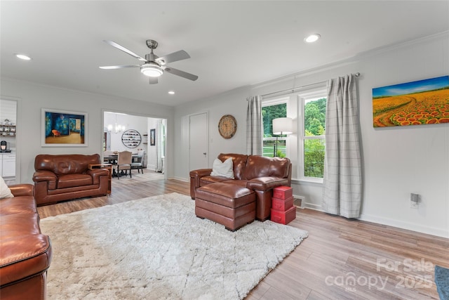509 N Oak St, Lincolnton, NC 28092 - living area featuring a ceiling fan, light wood-type flooring, baseboards, crown molding, and a chandelier