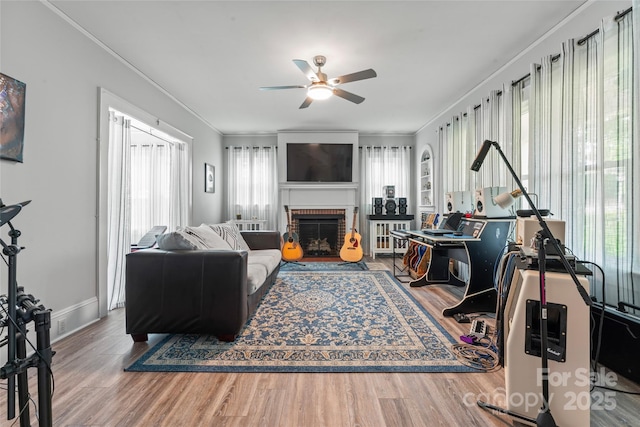 509 N Oak St, Lincolnton, NC 28092 - living area featuring a ceiling fan, wood finished floors, ornamental molding, a brick fireplace, and baseboards