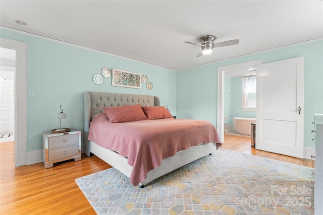 509 N Oak St, Lincolnton, NC 28092 - bedroom featuring light wood-style flooring, connected bathroom, and baseboards
