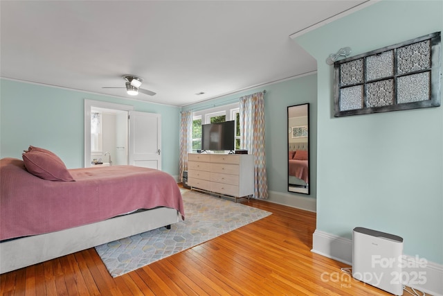 509 N Oak St, Lincolnton, NC 28092 - bedroom with baseboards, hardwood / wood-style floors, ensuite bath, and ceiling fan