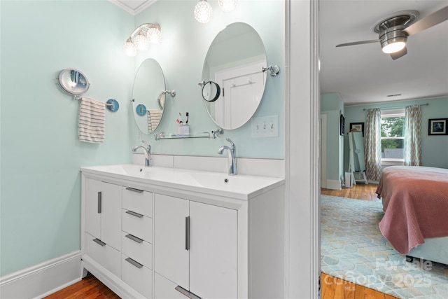 509 N Oak St, Lincolnton, NC 28092 - bathroom with ensuite bathroom, double vanity, wood finished floors, a ceiling fan, and baseboards