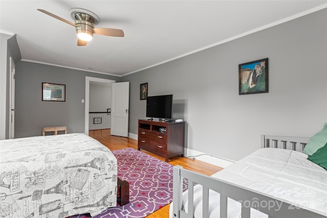 509 N Oak St, Lincolnton, NC 28092 - bedroom featuring ornamental molding, wood finished floors, radiator, a ceiling fan, and baseboards