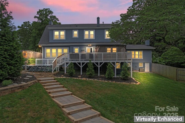 509 N Oak St, Lincolnton, NC 28092 - back of property at dusk featuring a deck, a chimney, stairway, and central AC