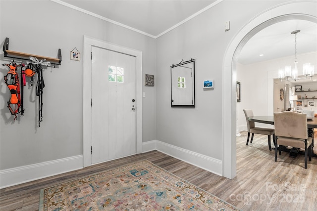 509 N Oak St, Lincolnton, NC 28092 - foyer with arched walkways, baseboards, wood finished floors, a chandelier, and ornamental molding