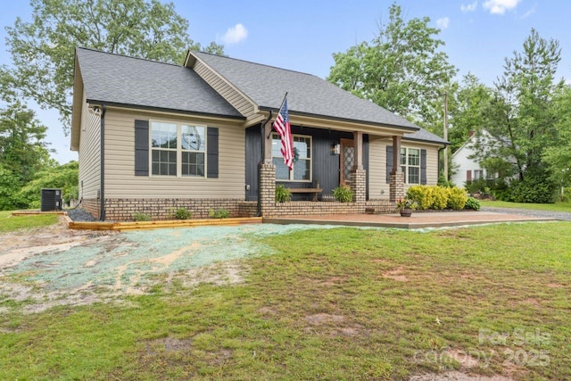 632 Skyland Dr N, Mount Pleasant, NC 28124 - view of front of property with cooling unit, a front lawn, roof with shingles, and covered porch