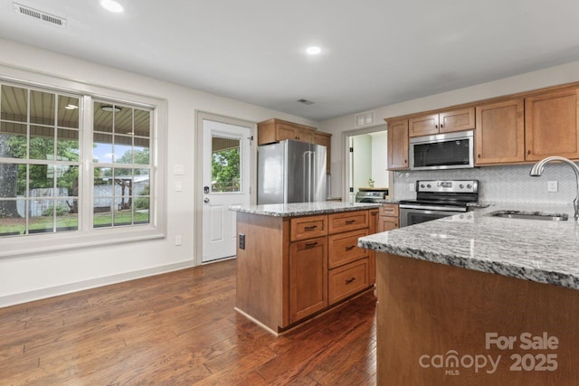632 Skyland Dr N, Mount Pleasant, NC 28124 - kitchen featuring stainless steel appliances, a sink, light stone countertops, a center island, and recessed lighting
