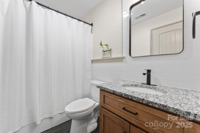 632 Skyland Dr N, Mount Pleasant, NC 28124 - bathroom with vanity, toilet, backsplash, tile walls, and shower / bath combo with shower curtain