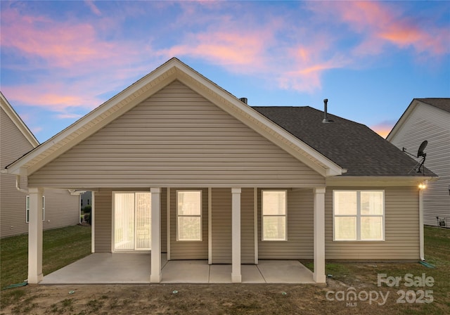 2236 Prairie Rd, Concord, NC 28027 - back of house at dusk with a patio and a shingled roof