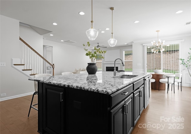 2236 Prairie Rd, Concord, NC 28027 - kitchen with a sink, dark cabinets, recessed lighting, a chandelier, and light wood-style floors