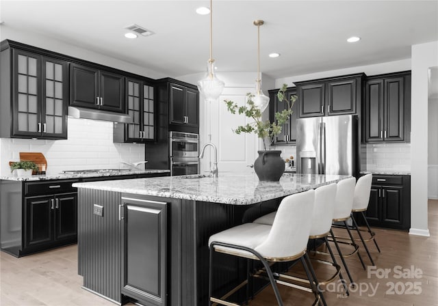 2236 Prairie Rd, Concord, NC 28027 - kitchen with dark cabinetry, backsplash, under cabinet range hood, and recessed lighting