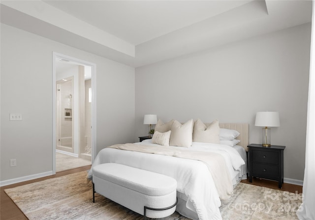 2236 Prairie Rd, Concord, NC 28027 - bedroom with wood finished floors, baseboards, a tray ceiling, and ensuite bath
