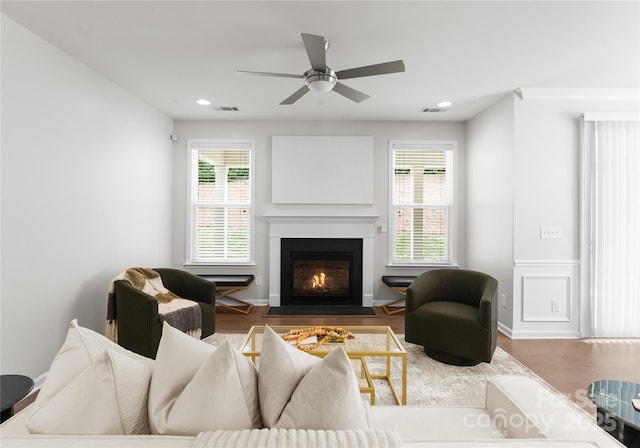 2236 Prairie Rd, Concord, NC 28027 - living room featuring a fireplace with flush hearth, wood finished floors, a ceiling fan, recessed lighting, and wainscoting