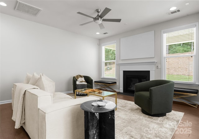 2236 Prairie Rd, Concord, NC 28027 - living room featuring a glass covered fireplace, a ceiling fan, wood finished floors, baseboards, and recessed lighting
