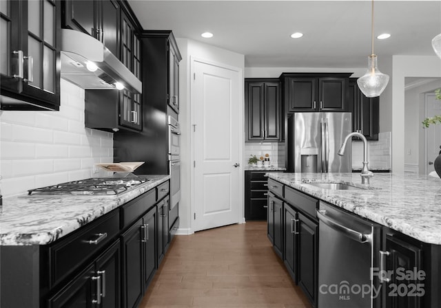 2236 Prairie Rd, Concord, NC 28027 - kitchen with appliances with stainless steel finishes, wall chimney range hood, dark cabinetry, and recessed lighting