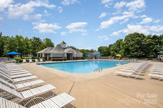 16121 Wrights Ferry Rd, Charlotte, NC 28278 - community pool featuring a patio area and view of wooded area