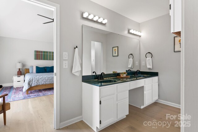 5 Loridon Dr, Weaverville, NC 28787 - bathroom featuring wood finished floors, double vanity, baseboards, and ensuite bathroom