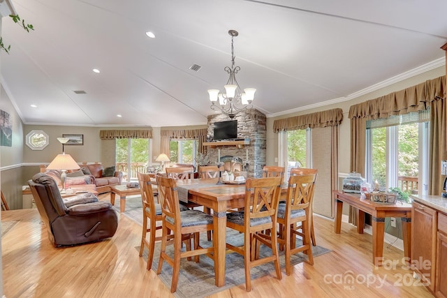 274 Slippery Rock Rd, Waynesville, NC 28785 - dining space featuring light wood-style flooring, a chandelier, healthy amount of natural light, and crown molding