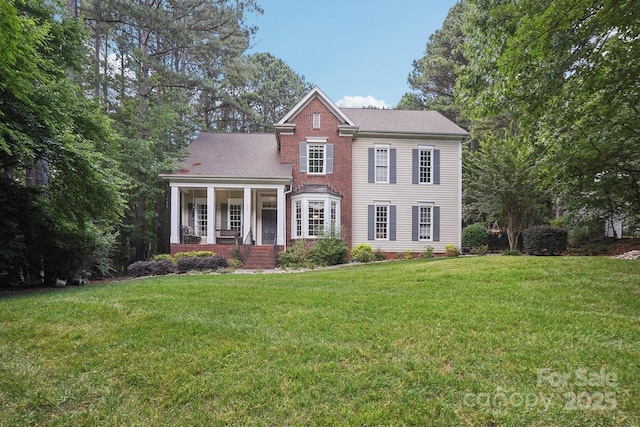 134 Lake Spring Loop, Mooresville, NC 28117 - view of front of property with a front yard, covered porch, and brick siding