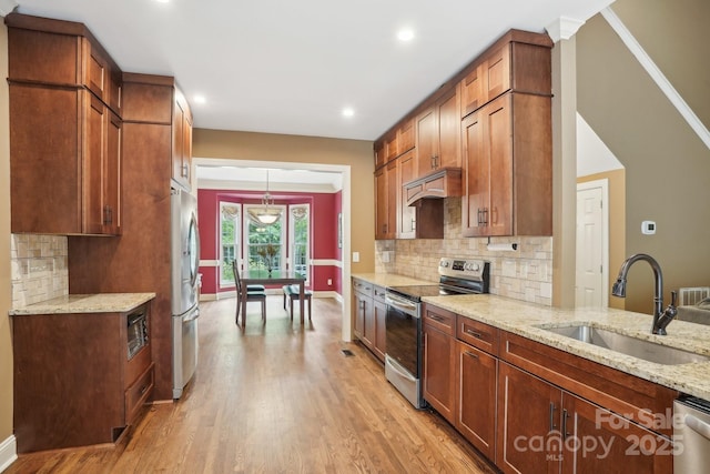 134 Lake Spring Loop, Mooresville, NC 28117 - kitchen with appliances with stainless steel finishes, a sink, light wood finished floors, light stone counters, and recessed lighting