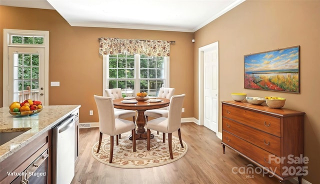 134 Lake Spring Loop, Mooresville, NC 28117 - dining room featuring light wood-type flooring, healthy amount of natural light, baseboards, and ornamental molding
