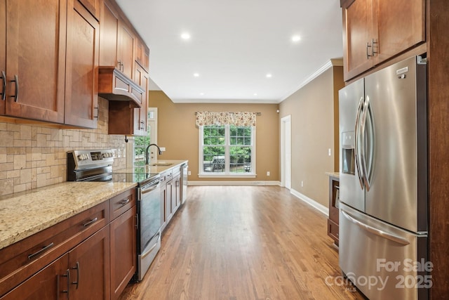 134 Lake Spring Loop, Mooresville, NC 28117 - kitchen featuring stainless steel appliances, a sink, custom range hood, light wood-style flooring, and crown molding