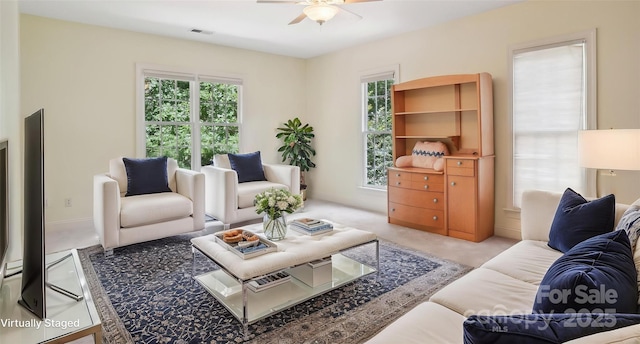 134 Lake Spring Loop, Mooresville, NC 28117 - carpeted living room featuring a ceiling fan and plenty of natural light