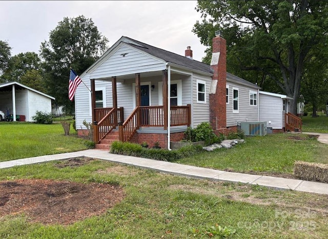 410 Gann St, Lowell, NC 28098 - bungalow-style home with cooling unit, a chimney, covered porch, and a front yard