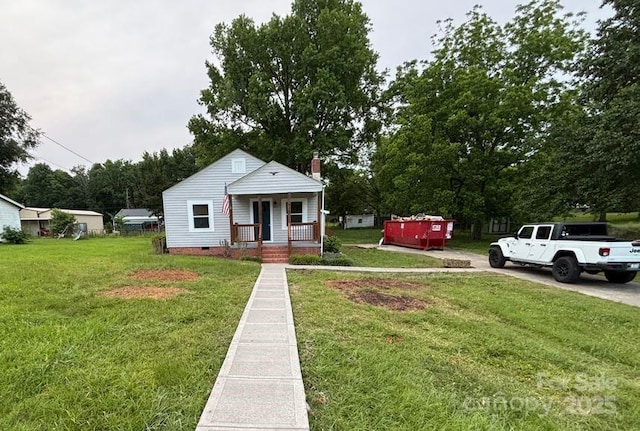 410 Gann St, Lowell, NC 28098 - bungalow-style house featuring a porch, a front lawn, a chimney, and crawl space