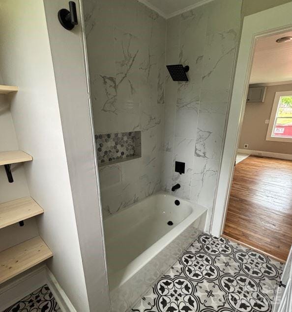 410 Gann St, Lowell, NC 28098 - bathroom featuring bathtub / shower combination, wood finished floors, and baseboards